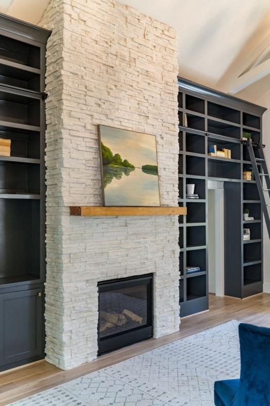 Modern White Stone Fireplace with Built-in Shelves
