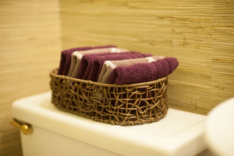 Neatly Folded Hand Towels in Woven Basket