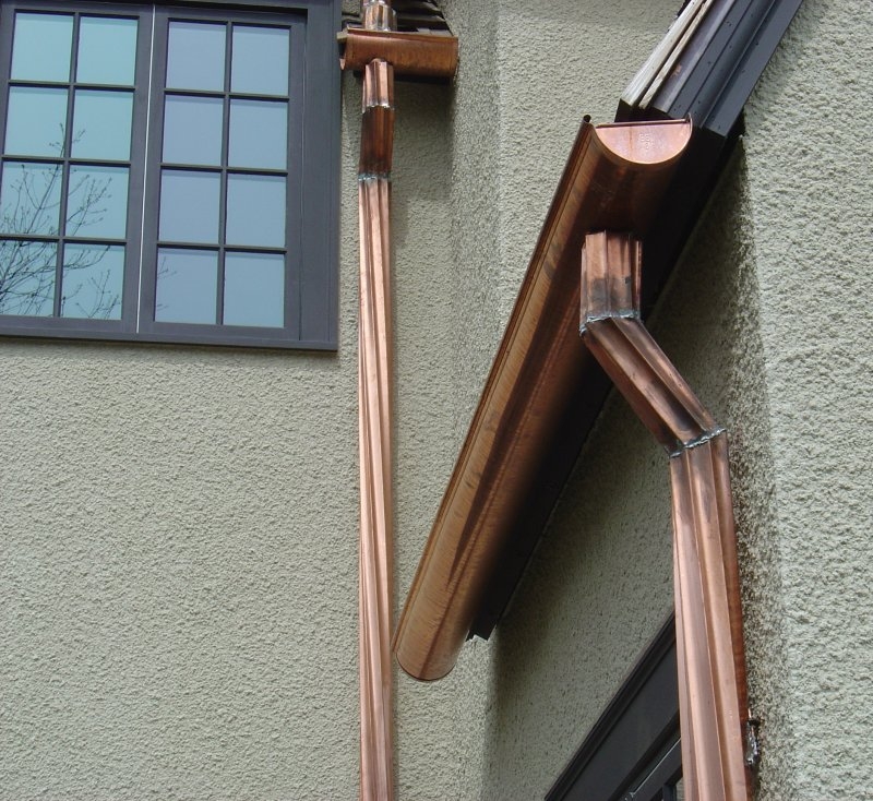 Ornamental Copper Downspouts on Textured Wall