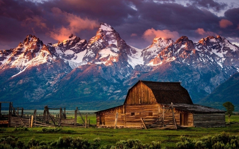 Rustic Cabin with Mountain Backdrop at Sunset