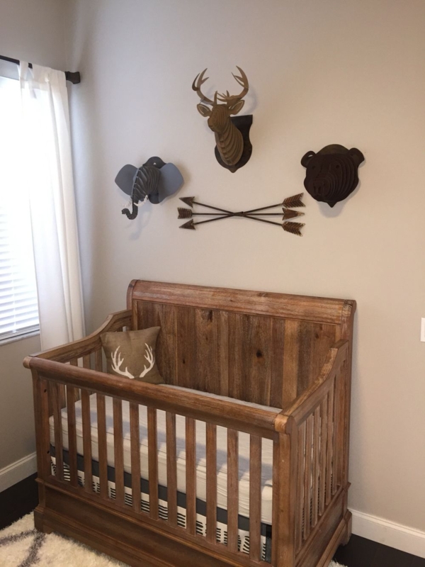 Rustic Wooden Baby Crib with Animal Wall Decor