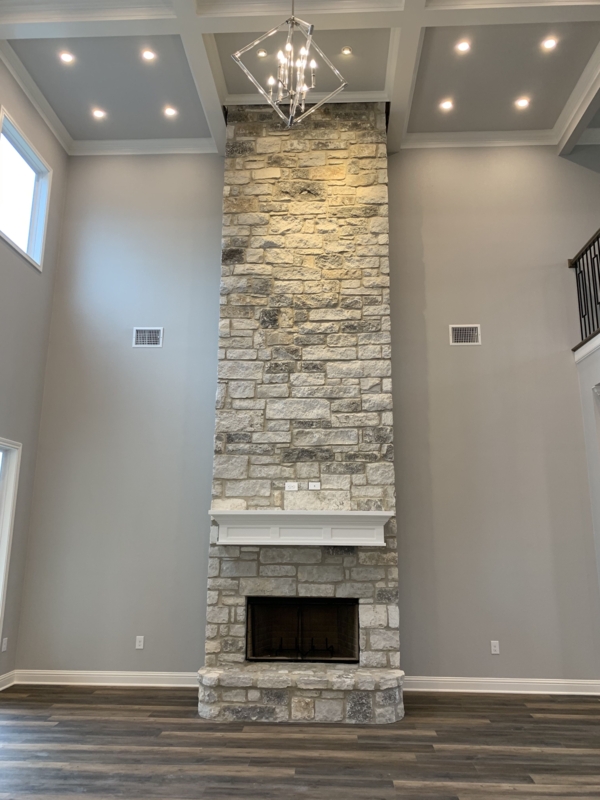 Tall Stone Fireplace with Modern High Ceiling