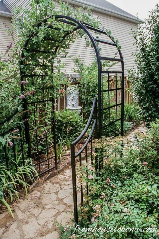 Black arched arbor with garden gate #plants | Garden gate design, Diy ...