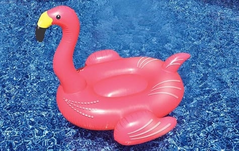 Bright Pink Flamingo Pool Float in Blue Water