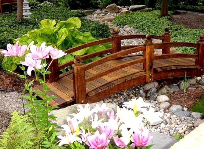 Charming Wooden Garden Bridge with Floral Surroundings