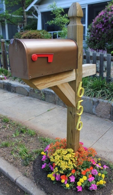 Charming Wooden Mailbox with Vibrant Flower Bed