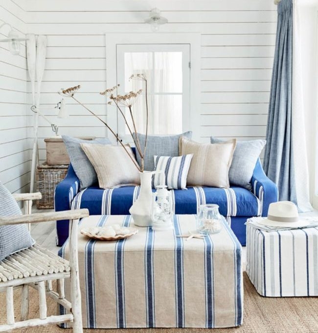 Coastal Living Room with Striped Ottomans and Blue Sofa