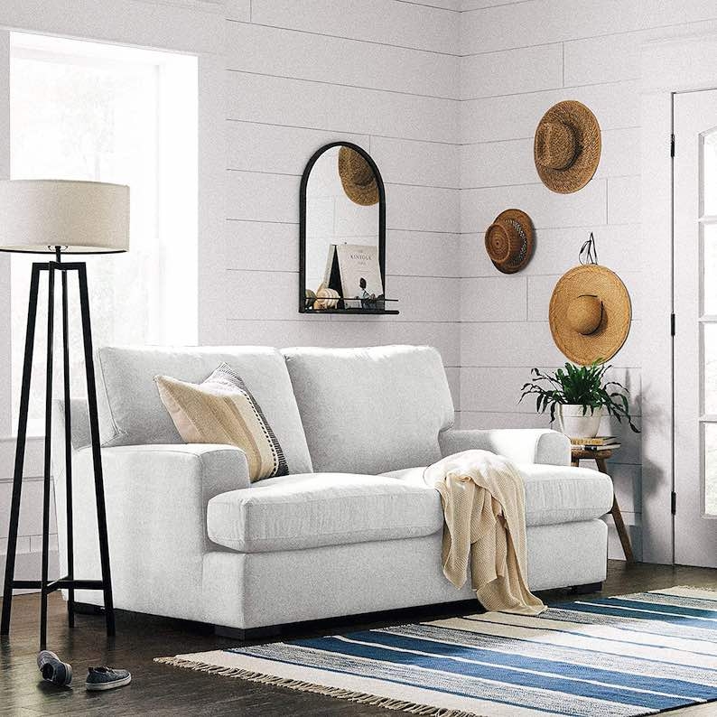 Coastal Living Room with White Sofa and Straw Hats