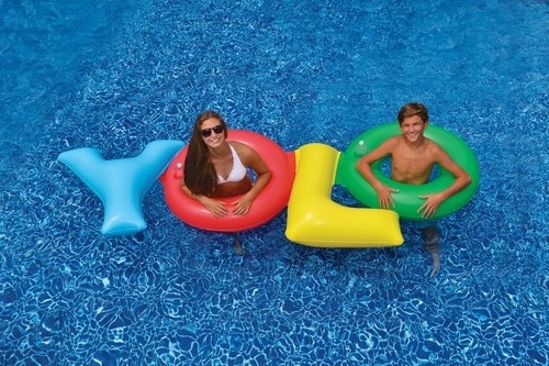 Colorful Christmas Pool Floats Saying 'YOLO'