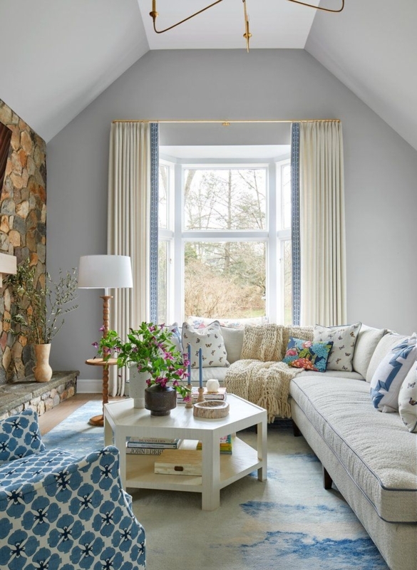 Cozy Living Room with Bay Window and Stone Fireplace
