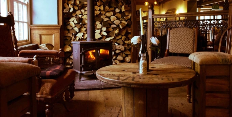 Cozy Rustic Pub Seating with Wood Burning Stove