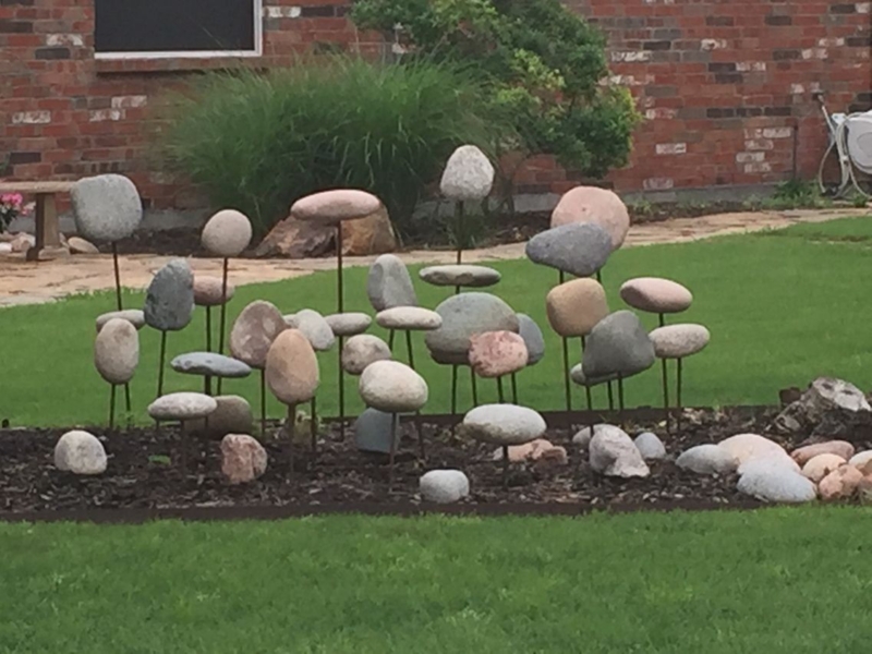 Creative Elevated Rock Display in Garden Flower Bed