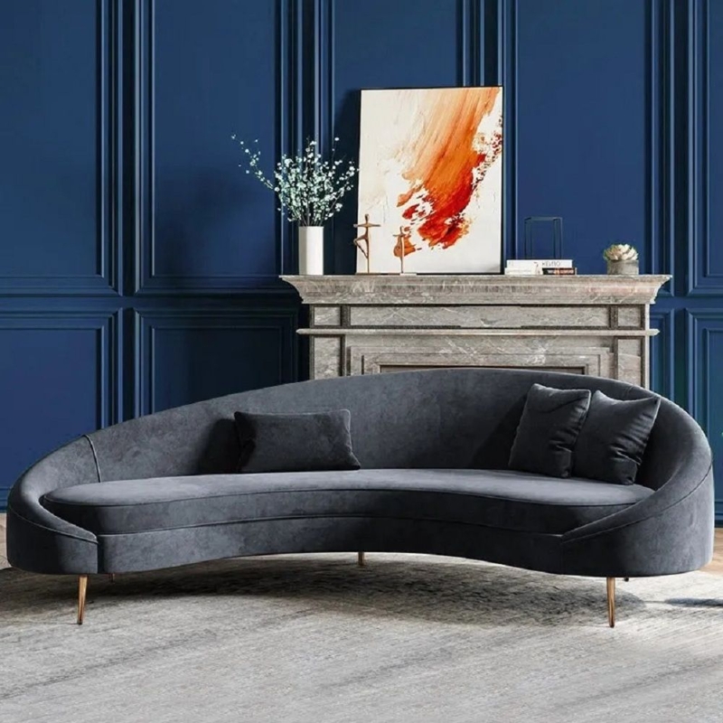 Curved Gray Sofa Against Elegant Navy Blue Wall
