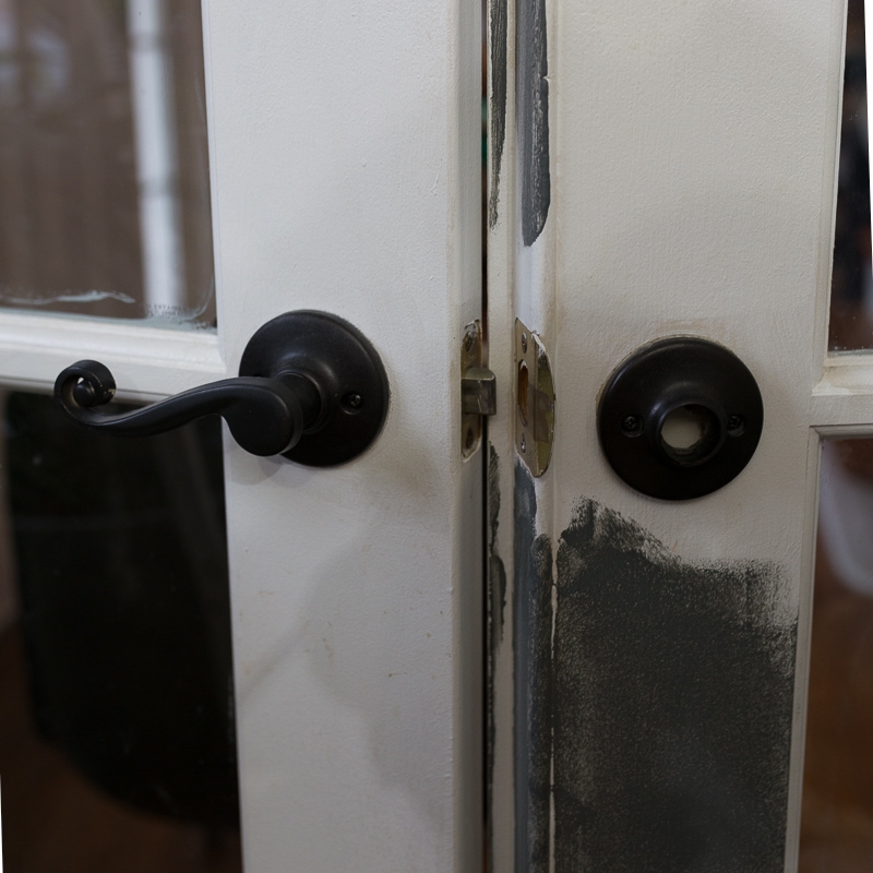 Elegant Black Handles on White French Doors