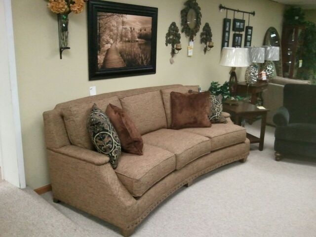 Elegant Crescent Shaped Brown Sofa with Cushions