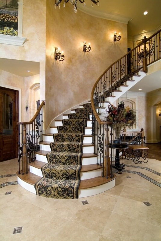 Elegant Curved Staircase with Classic Wall Sconces