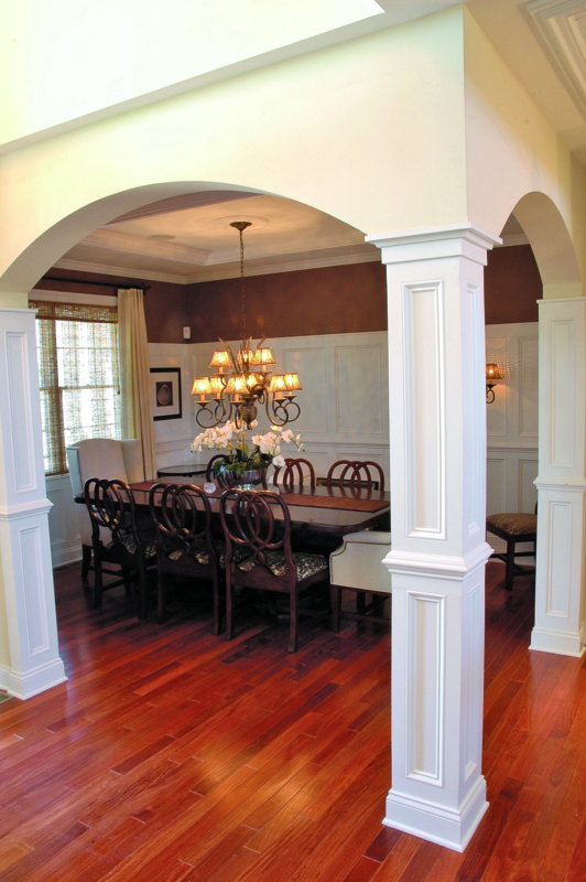 Elegant Dining Room with Classic Arches and Wood Flooring