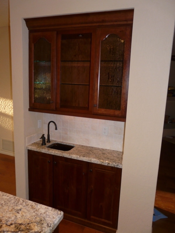Elegant Home Bar with Dark Wood and Granite Countertop