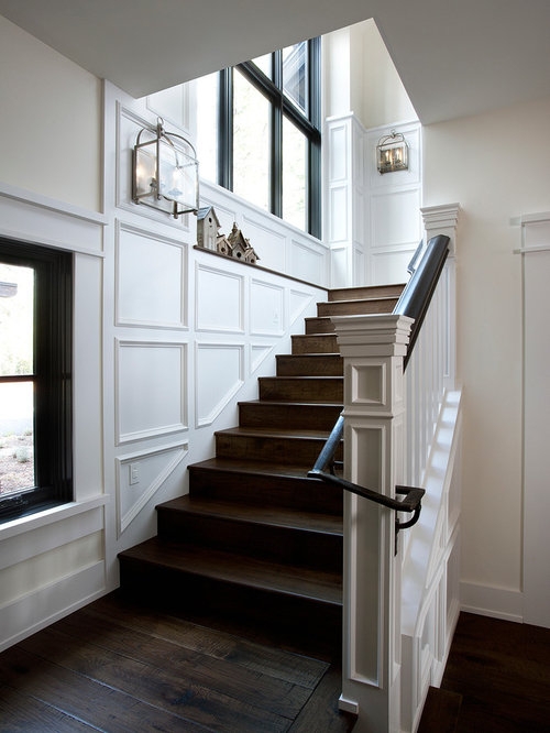 Elegant Stairway Sconces with Classic White Paneling