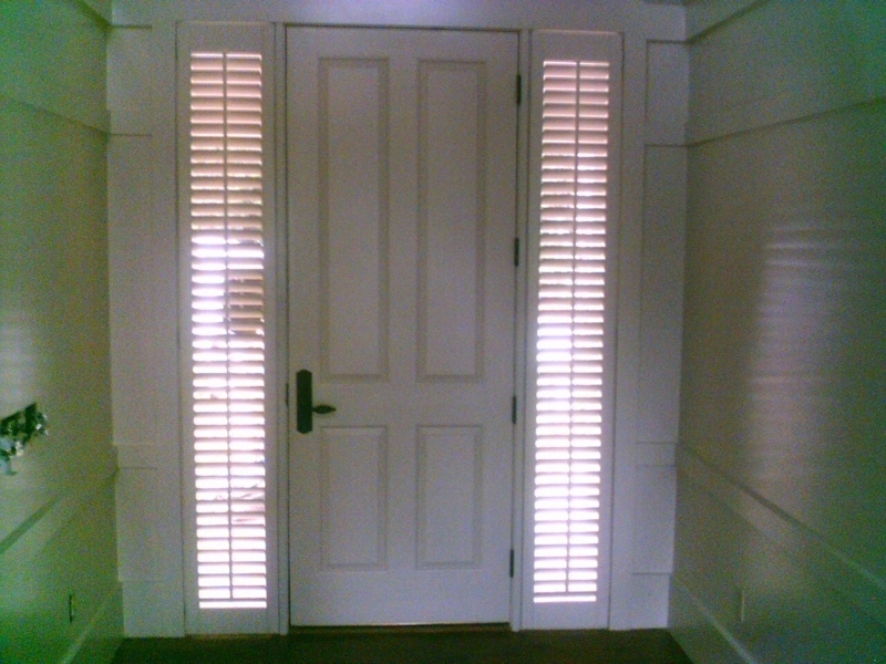 Elegant White Plantation Shutters Flanking Front Door