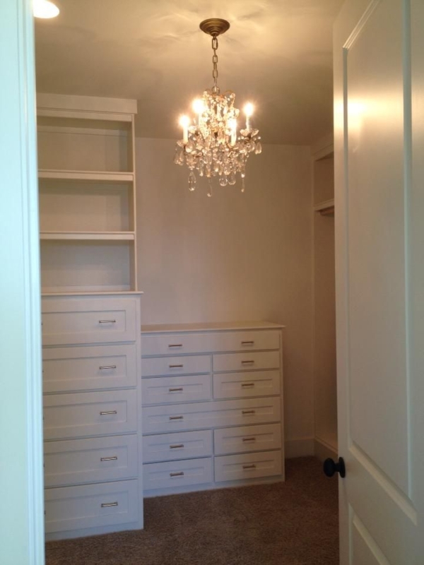 Elegant White Walk-In Closet with Crystal Chandelier