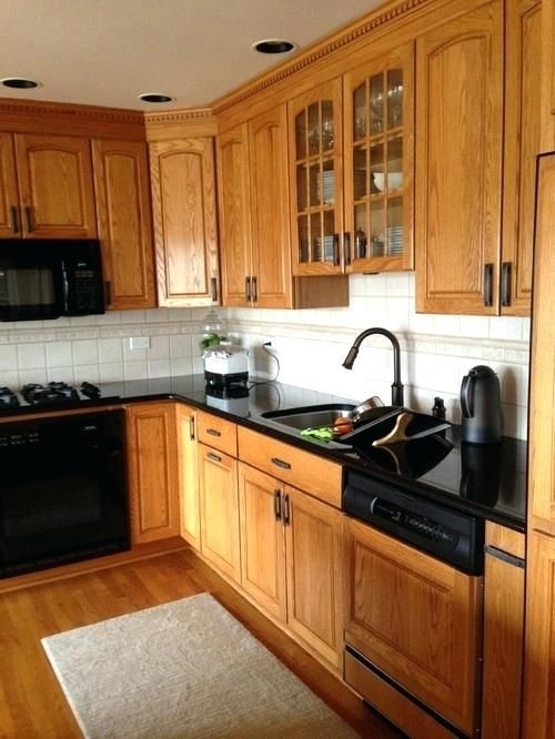 Honey Oak Kitchen Cabinets with Black Countertop