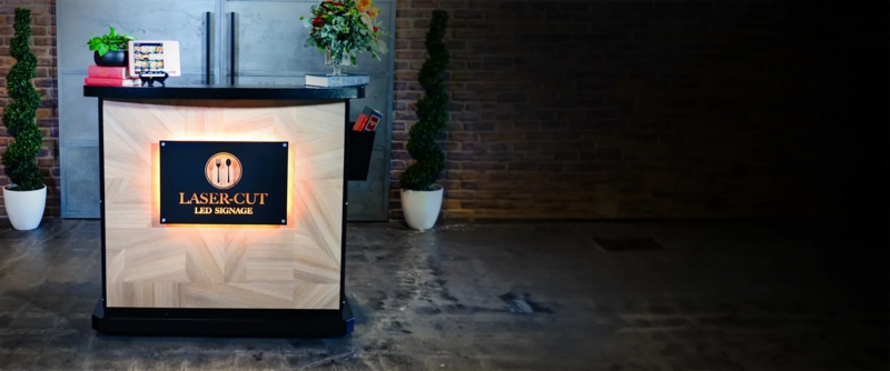 Modern Hostess Station with LED Signage and Wood Paneling