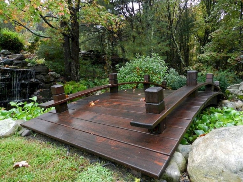 Rustic Wooden Garden Bridge Over Stream