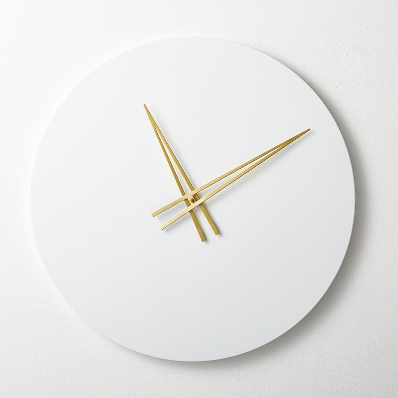 Shop Ora White Wall Clock. Minimalist hi-gloss white wall clock keeps ...
