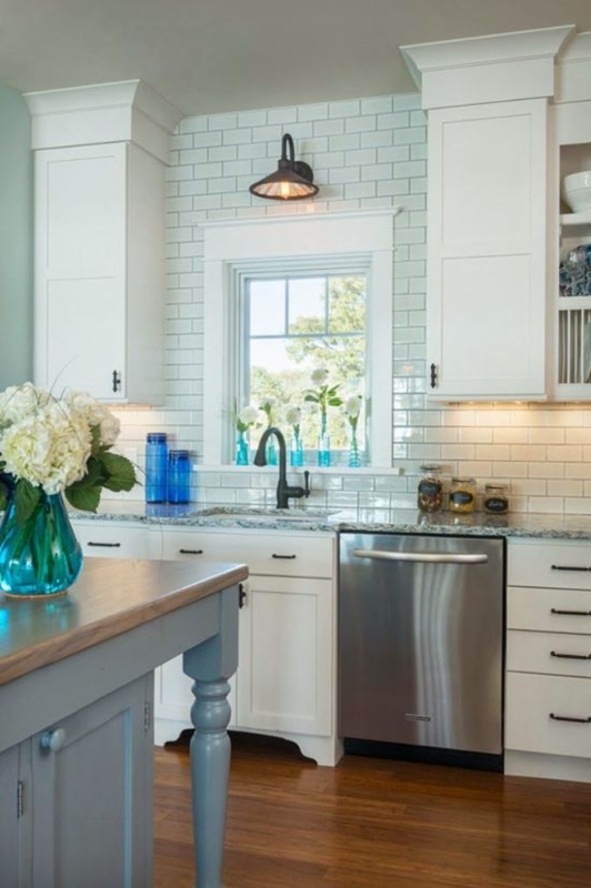 White Kitchen with Elegant Corner Lighting and Subway Tiles