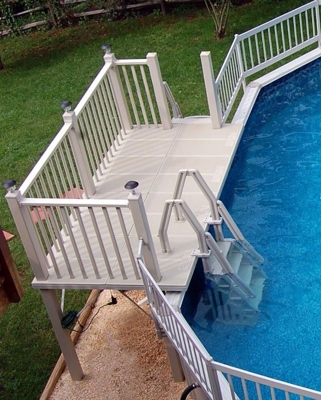 an above ground swimming pool with steps leading up to the deck and ...