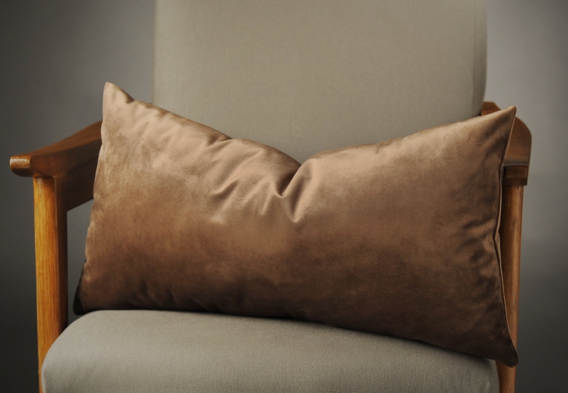 Brown Velvet Lumbar Pillow on Wooden Chair