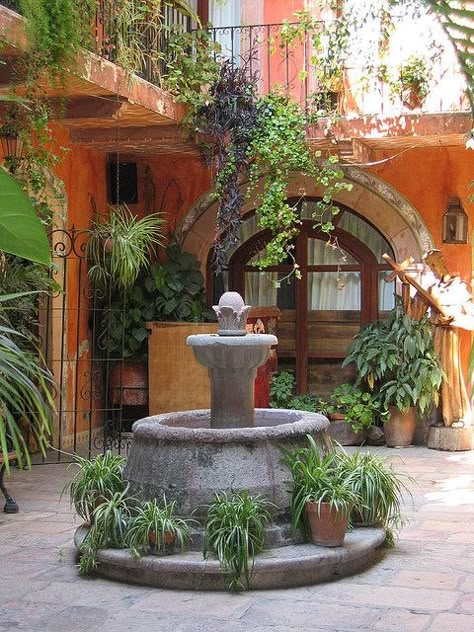 Charming Spanish Courtyard Fountain with Lush Greenery