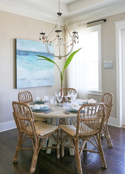 Coastal Dining Room with Rattan Chairs and Sea Art