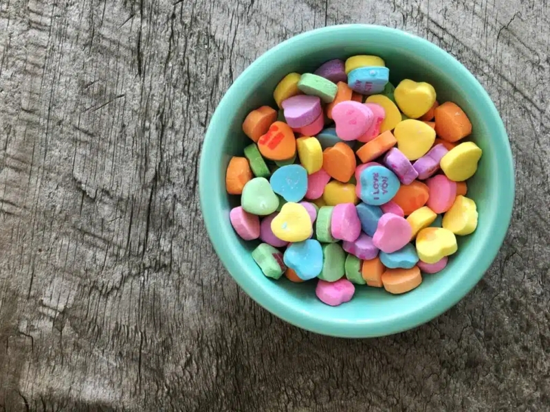Colorful Candy Hearts in Blue Ceramic Bowl