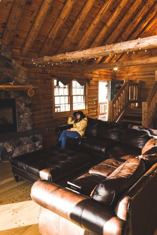 Cozy Cabin Living Room with Leather Couch and Fireplace