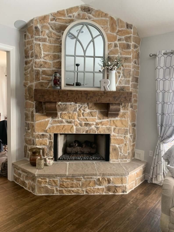 Cozy Rustic Stone Corner Fireplace with Wood Mantel