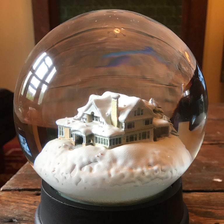Cozy Snow-Covered House Inside Snow Globe
