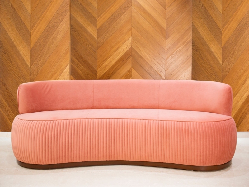 Elegant Coral Velvet Sofa with Wooden Chevron Wall
