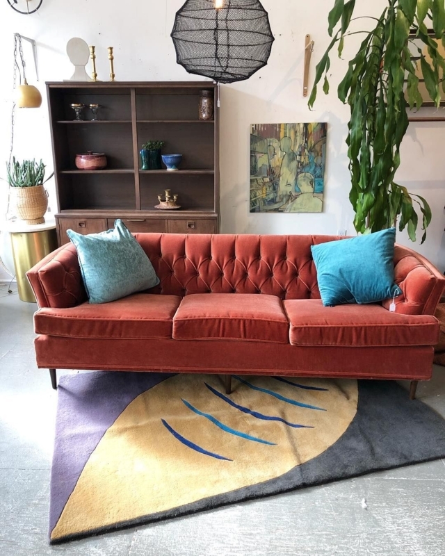 Living Coral Velvet Sofa with Blue Accent Pillows
