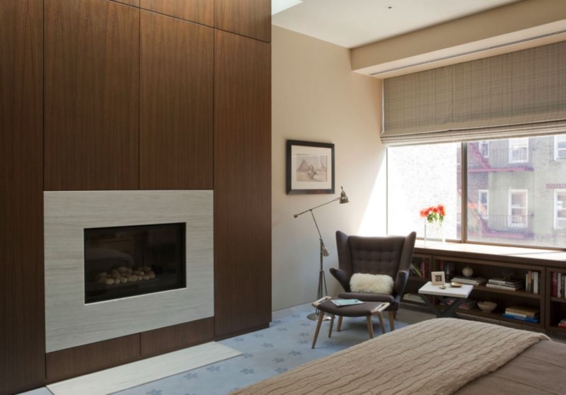 Modern Bedroom with Warm Wood Paneling and Fireplace