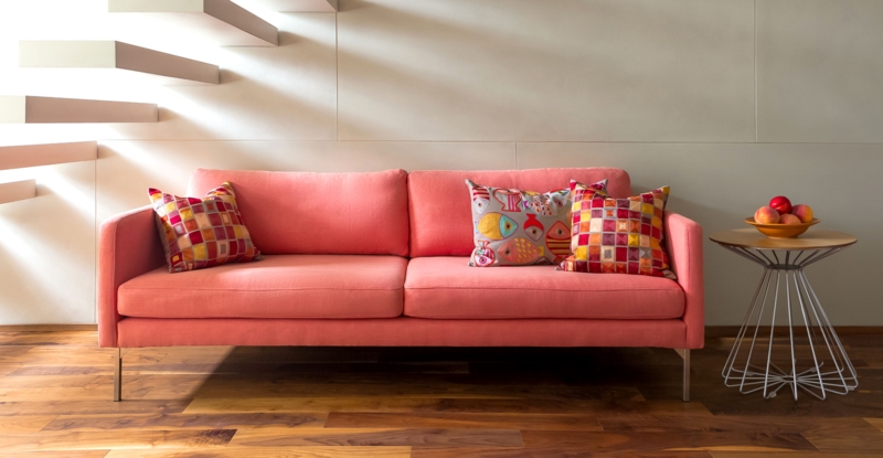 Modern Coral Red Sofa with Patterned Accent Pillows