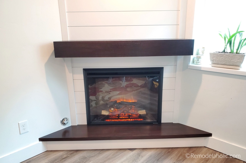 Modern Corner Fireplace with Dark Wooden Mantel