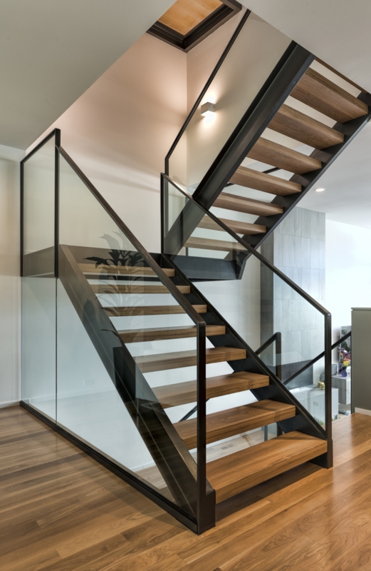 Modern Glass and Wood Staircase with Wall Sconce