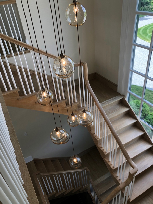 Modern Glass Pendant Lighting Over Wooden Staircase