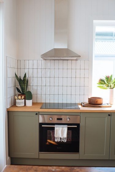 Modern Green Cabinets with Vertical Subway Tile Backsplash