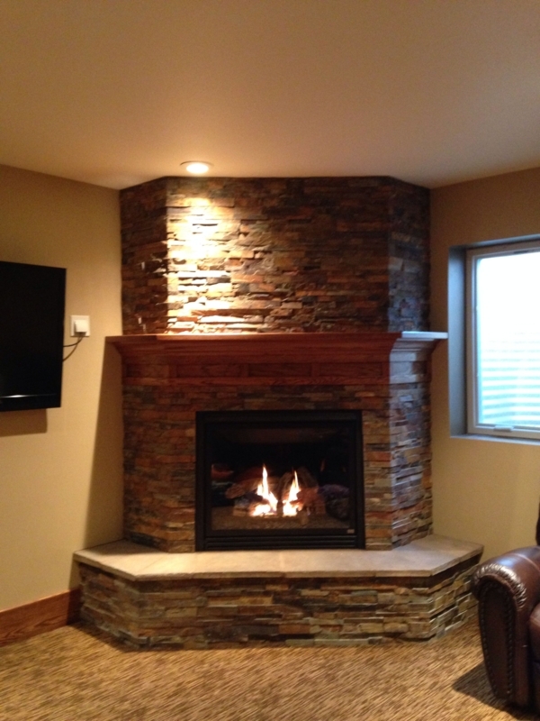 Rustic Stone Corner Fireplace with Wooden Mantel