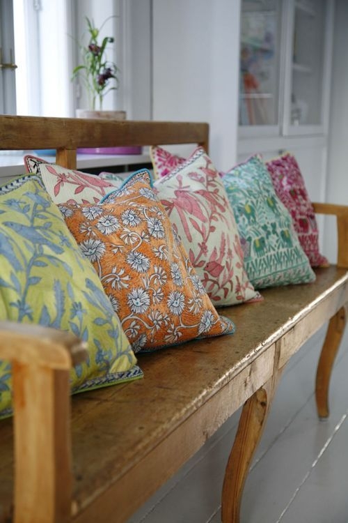 Colorful Floral Cushions on Rustic Wooden Bench