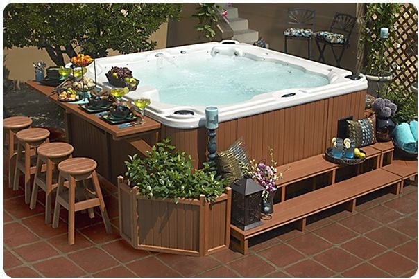 Cozy Backyard Hot Tub with Integrated Seating and Greenery