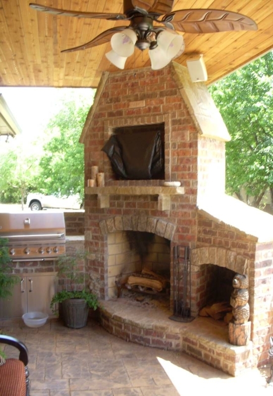 Cozy Brick Backyard Patio Fireplace with Grill